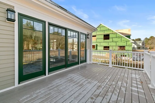 a view of a house with wooden deck
