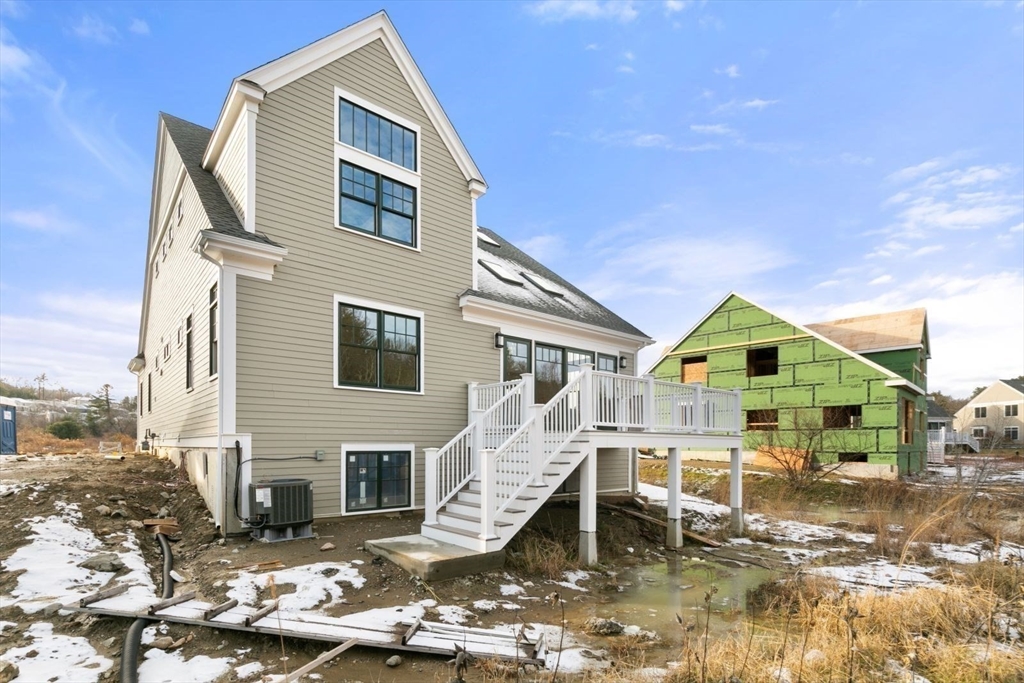 9 Adams Lane, Unit 9 Sherborn, MA 01770 - Photo 21 of 26 a front view of a house with a yard