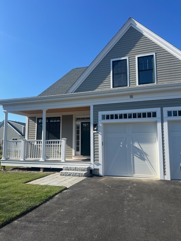 9 Adams Lane, Unit 9 Sherborn, MA 01770 - Photo 22 of 26 a front view of a house with a garden and fence