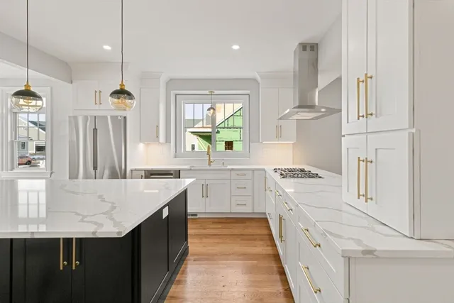 a kitchen with granite countertop a sink stove and refrigerator