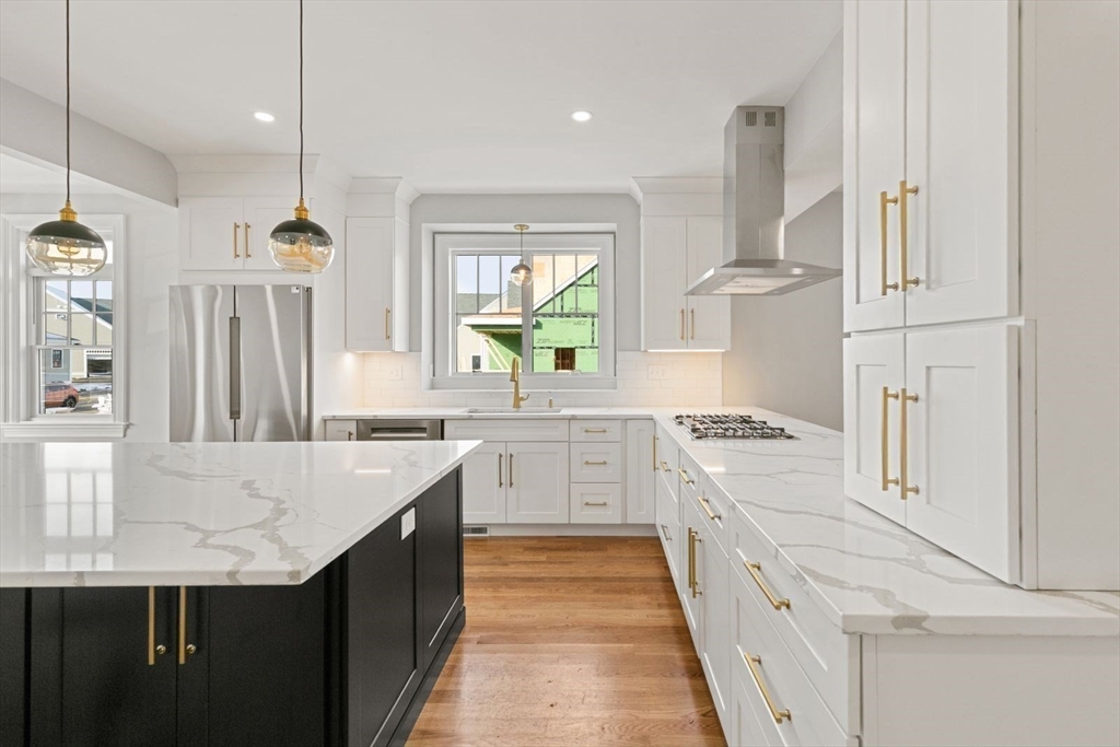 9 Adams Lane, Unit 9 Sherborn, MA 01770 - Photo 5 of 26 a kitchen with granite countertop a sink stove and refrigerator