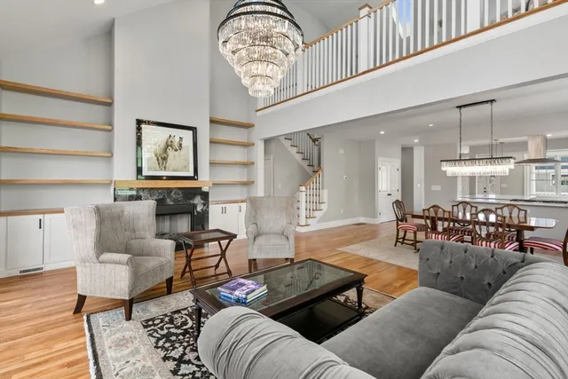 a living room with furniture a rug and white walls