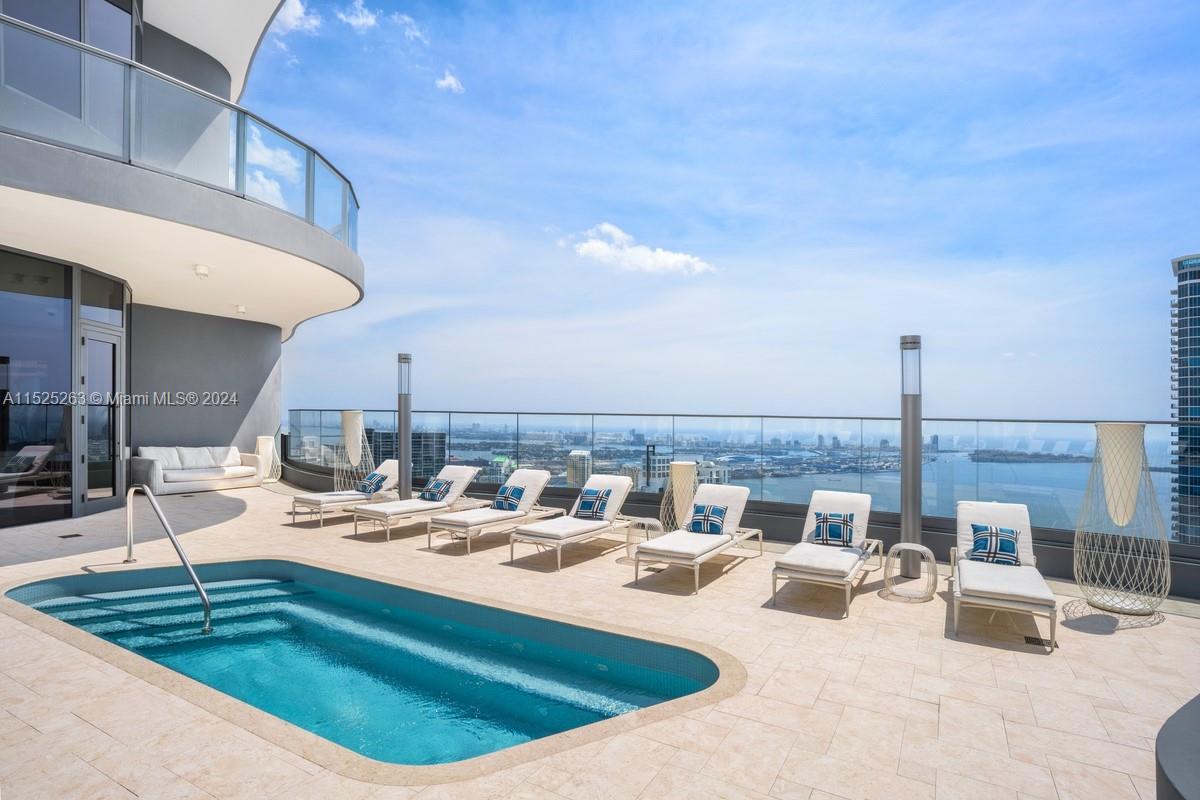 1000 Brickell Plaza, Unit 4101 Miami, FL 33131 - Photo 18 of 24 a view of a swimming pool and dinning table and chairs