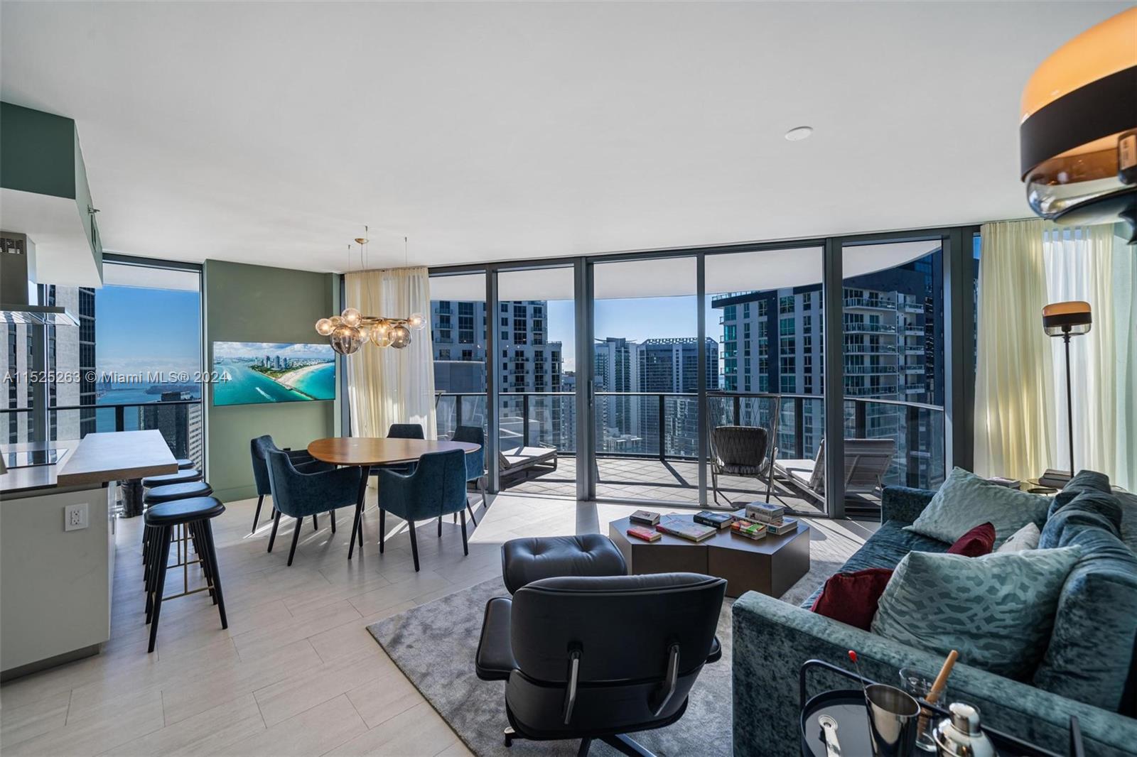 1000 Brickell Plaza, Unit 4101 Miami, FL 33131 - Photo 2 of 24 a living room with furniture a lamp and a floor to ceiling window