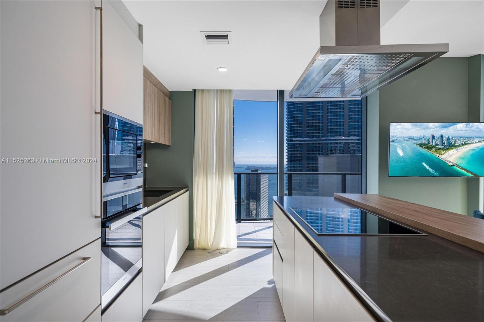 1000 Brickell Plaza, Unit 4101 Miami, FL 33131 - Photo 3 of 24 a kitchen with stainless steel appliances granite countertop a sink and a refrigerator