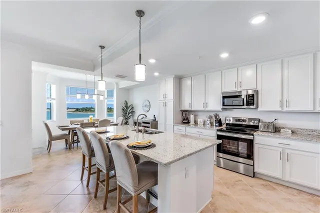 a large kitchen with a table and chairs