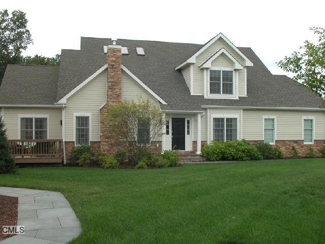 a front view of a house with a garden and yard