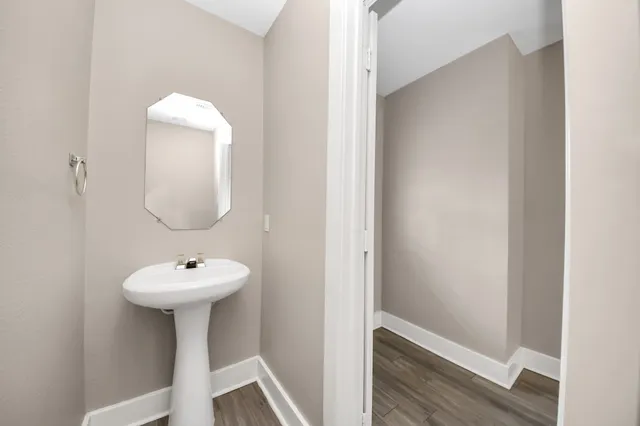 a bathroom with a sink toilet and a mirror