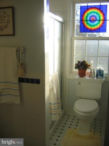 3808 Beckleysville Road Hampstead, MD 21074 - Photo 16 of 28 a bathroom with a toilet and a shower curtain