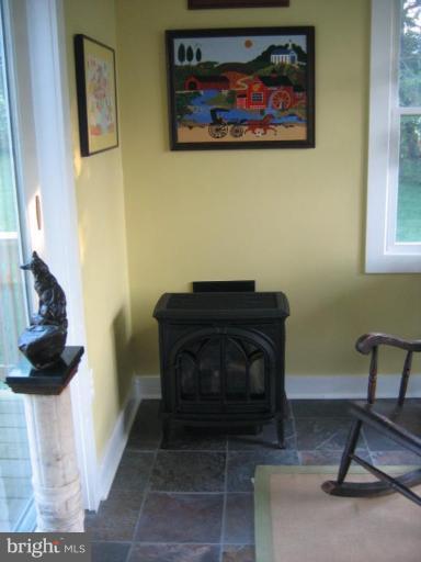 3808 Beckleysville Road Hampstead, MD 21074 - Photo 8 of 28 a living room with a piano and a fireplace