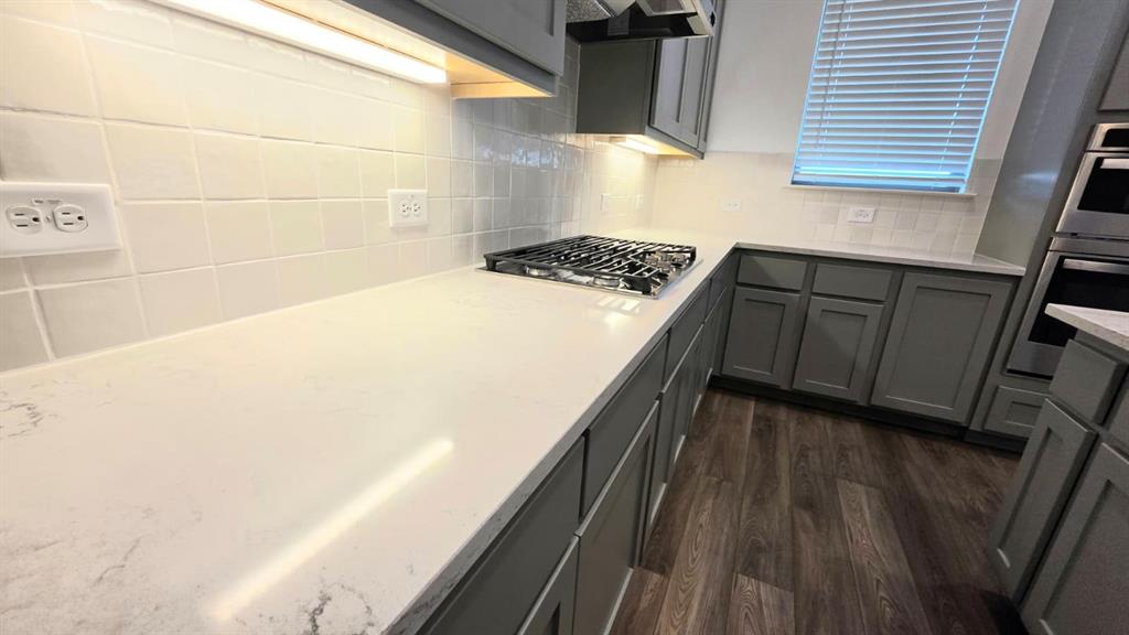 4201 Watson Way North Richland Hills, TX 76180 - Photo 11 of 40 a kitchen with wooden floors and a stove