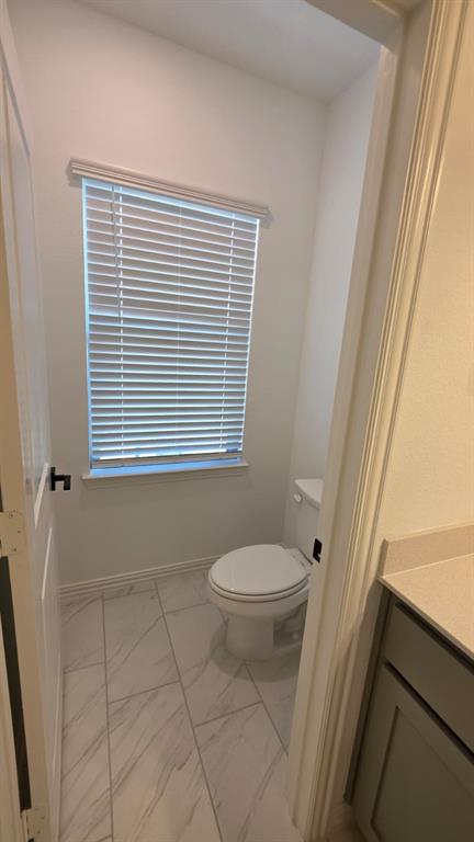 4201 Watson Way North Richland Hills, TX 76180 - Photo 21 of 40 a bathroom with a toilet a sink and a window