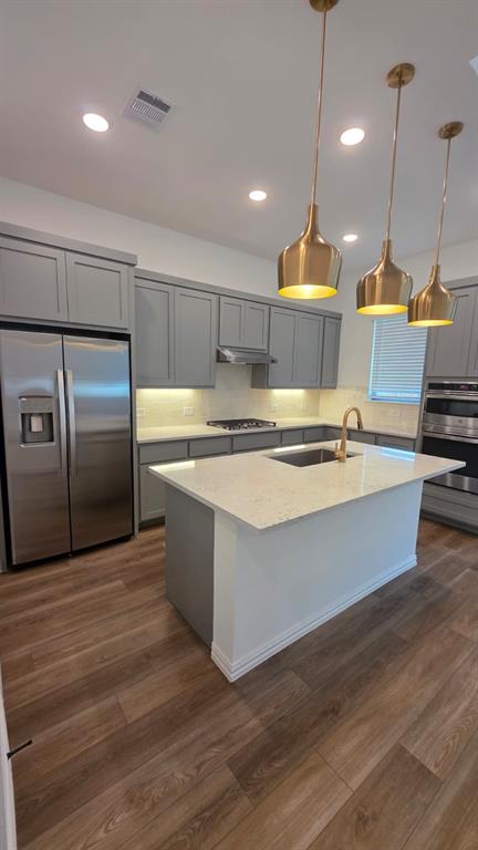 4201 Watson Way North Richland Hills, TX 76180 - Photo 5 of 40 a large kitchen with kitchen island a large counter top a sink and stainless steel appliances
