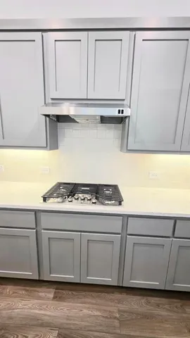a stove top oven sitting inside of a kitchen