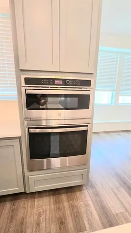 a stove top oven sitting inside of a kitchen