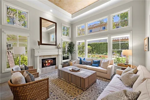 a living room with furniture large window and fireplace