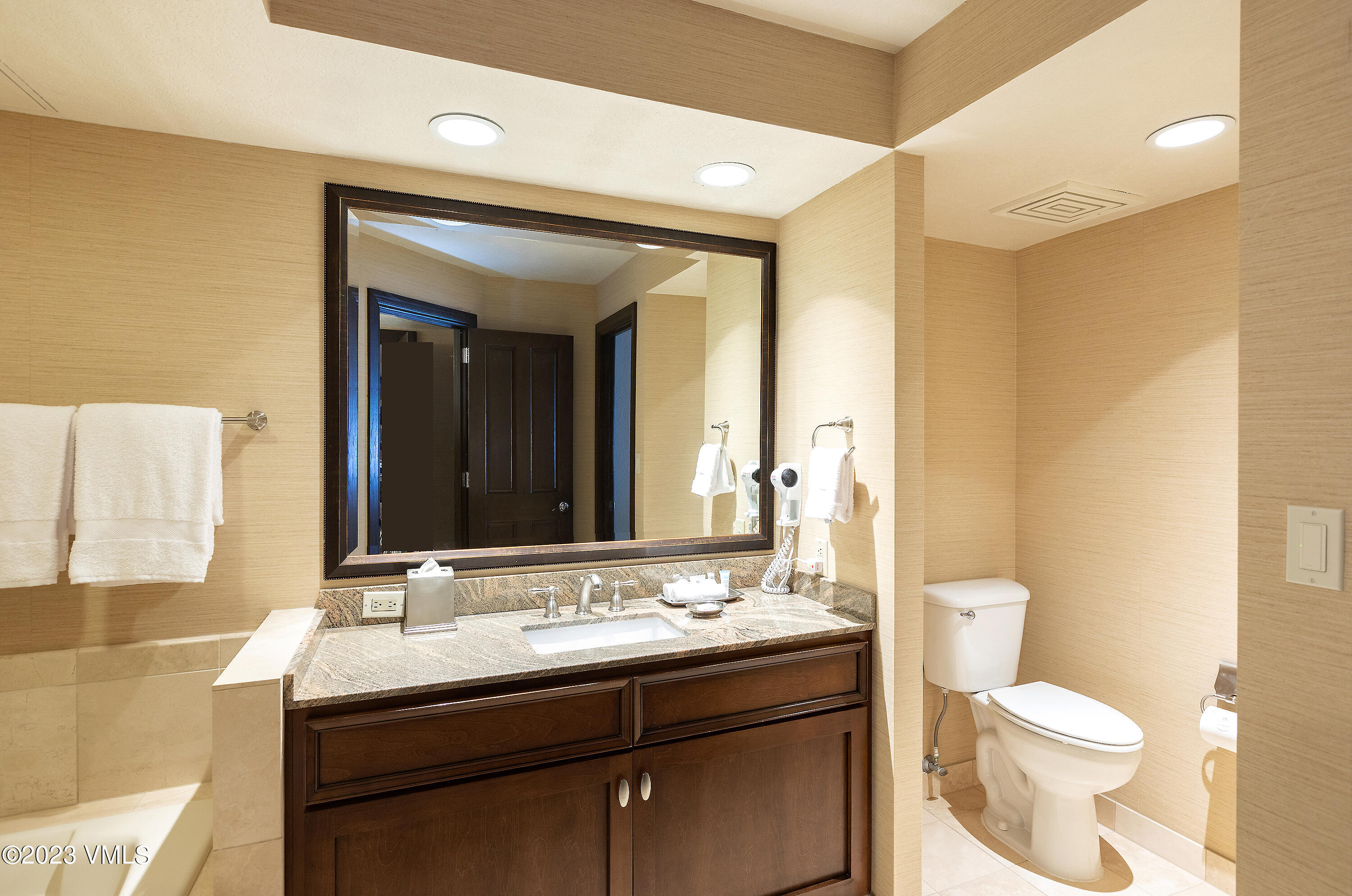 210 Offerson Road, Unit 207 WEEK 34 Beaver Creek, CO 81620 - Photo 17 of 26 a bathroom with a granite countertop sink toilet and mirror