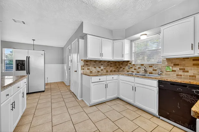 a kitchen with a sink a stove and refrigerator