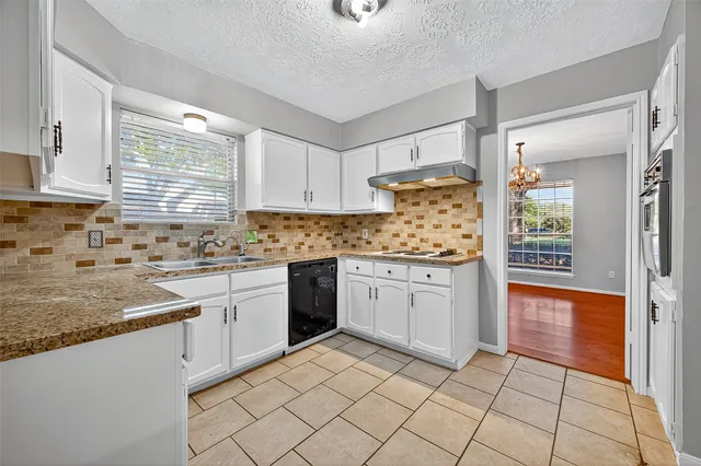 a kitchen with a sink window and cabinets
