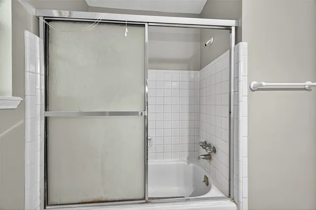 a bathroom with a glass shower door