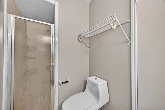 a bathroom with a toilet and a shower