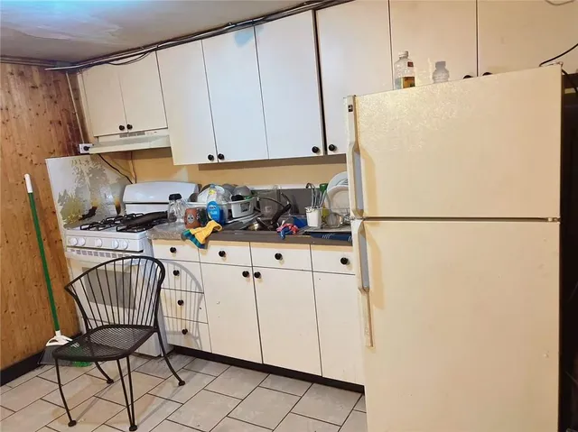 a kitchen with stainless steel appliances a refrigerator sink and cabinets