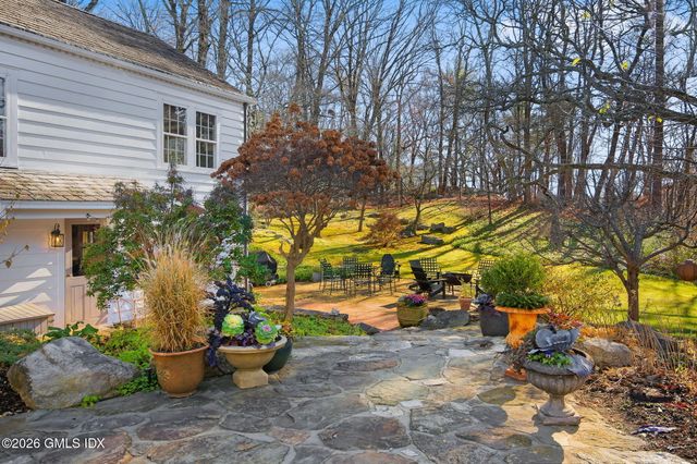 a view of a backyard with sitting area