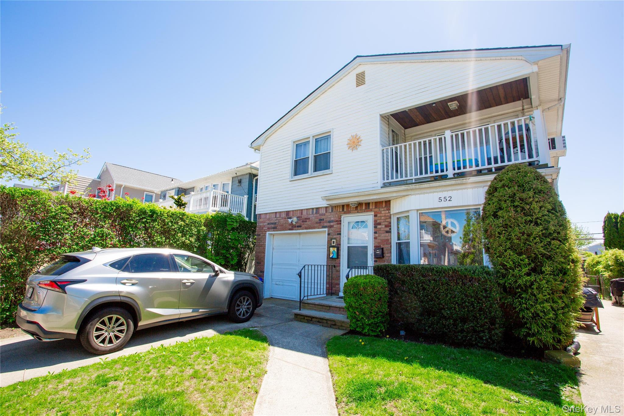 552 East Walnut Street, Unit UPPR Long Beach, NY 11561 - Photo 1 of 1 a front view of a house with garden