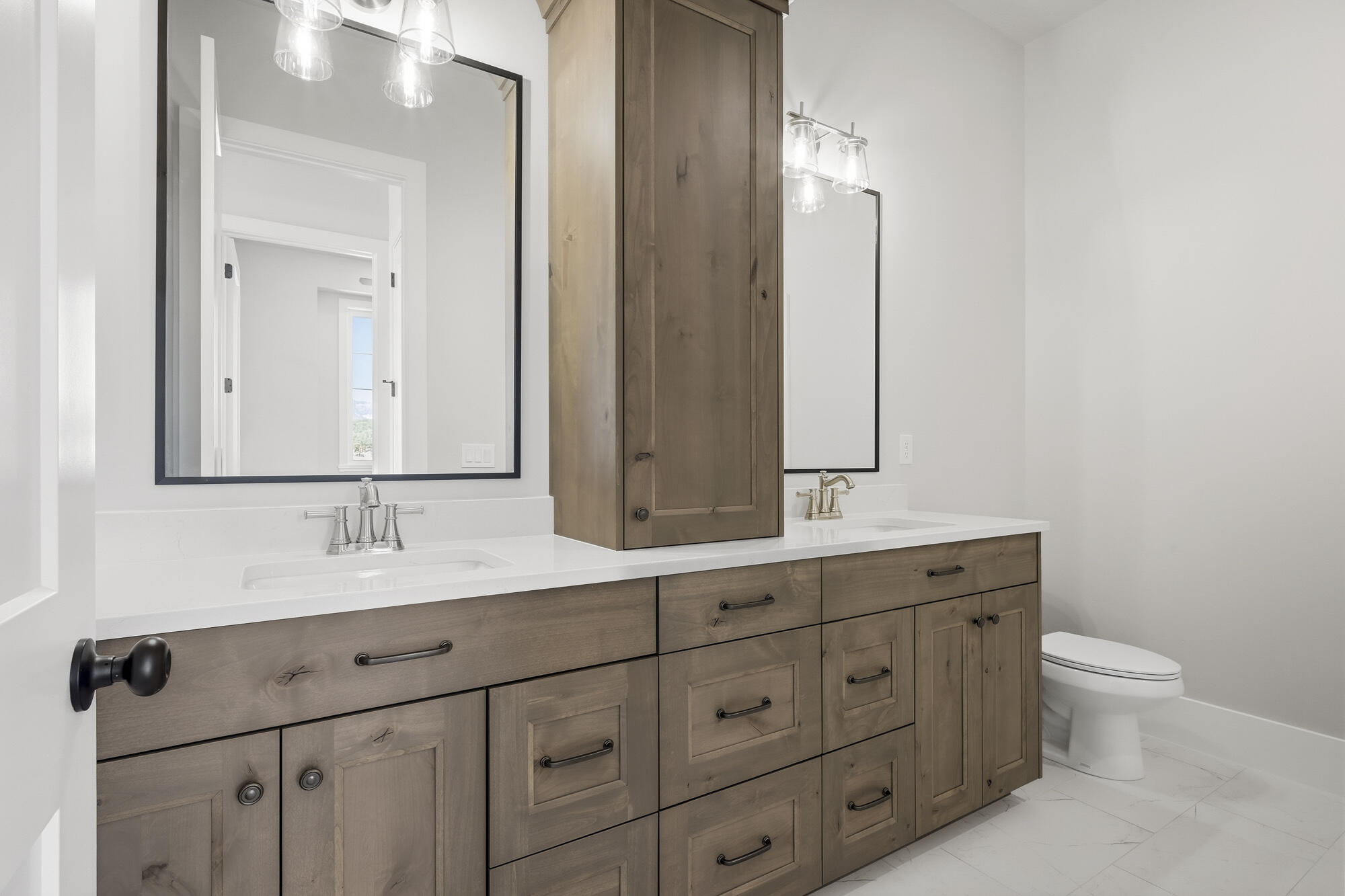1852 South Hidden Canyon Road Cedar City, UT 84720 - Photo 37 of 79 The secondary bath is located near Bedrooms 2 & 3 and features a large vanity with dual sinks, a bonus upper cabinet, and tile flooring.