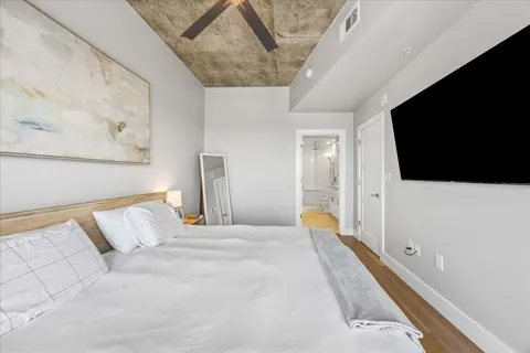 a bedroom with a bed and a flat screen tv