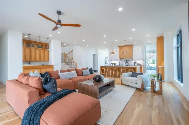 a living room with furniture and kitchen view