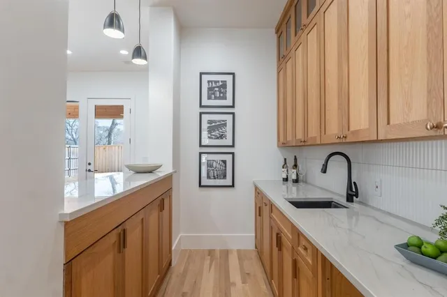 a kitchen with stainless steel appliances granite countertop a sink stove and cabinets