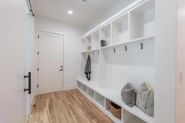 a hallway with painting on the wall