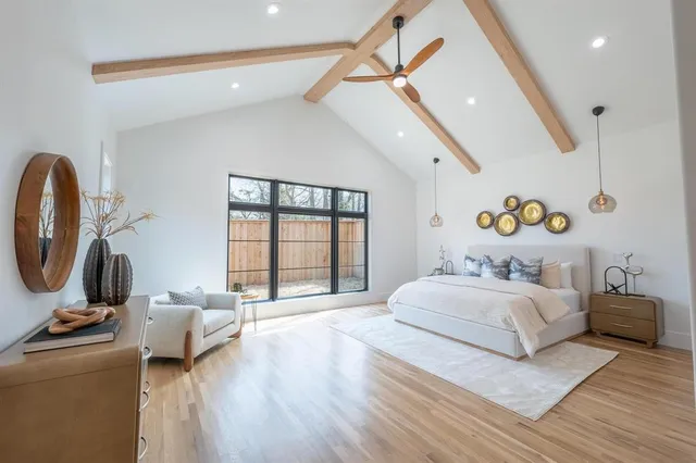 a bedroom with a bed couch and a window