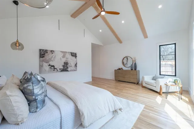 a spacious bedroom with a bed and furniture