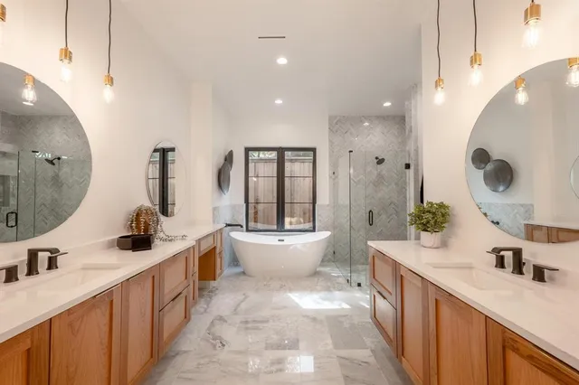 a bathroom with a double vanity sink a toilet and mirror
