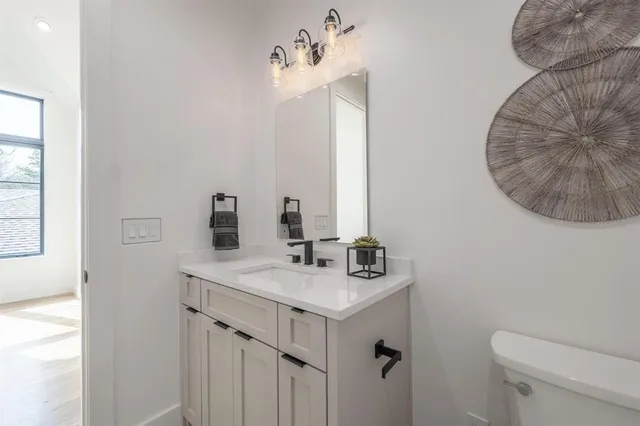 a bathroom with a sink vanity and a mirror