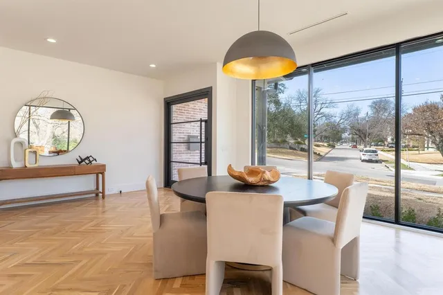 a dining room with furniture and a large window