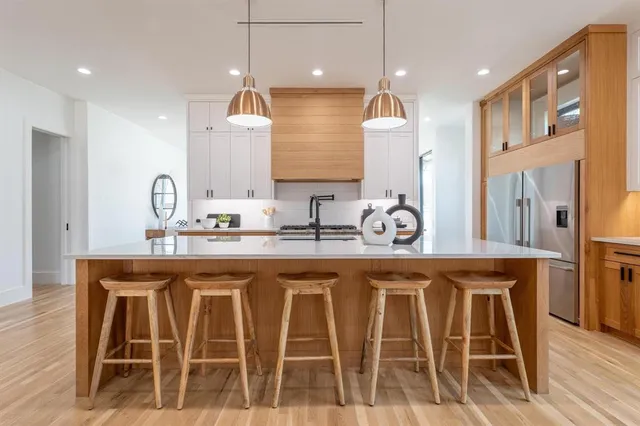 a kitchen with white cabinets and sink