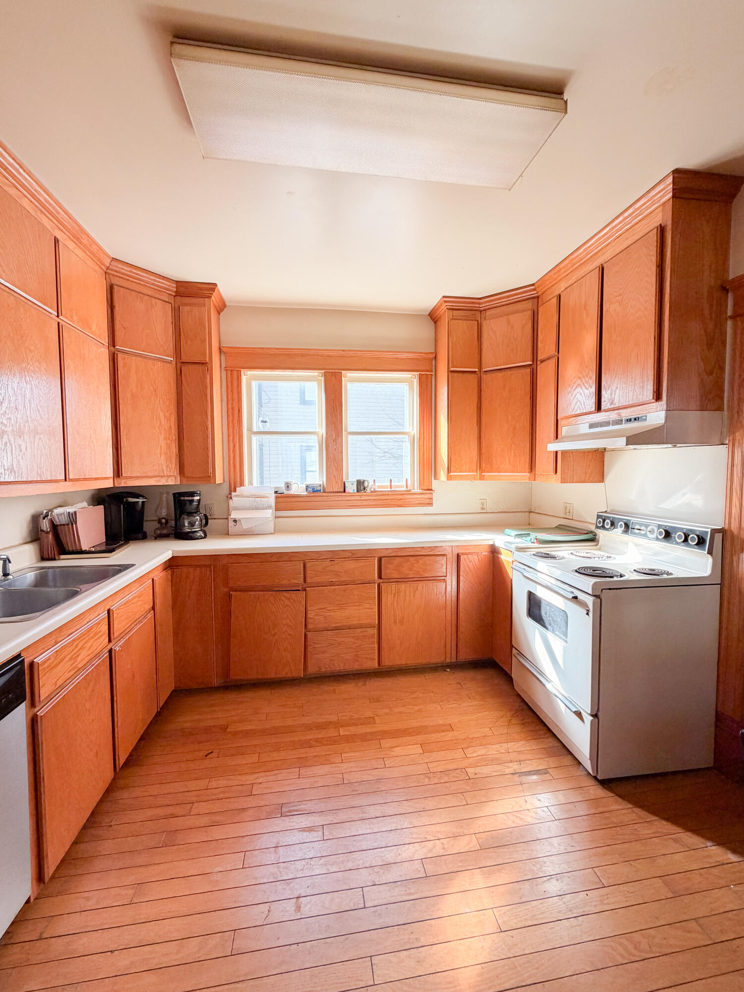 226 West Locust Street Covington, VA 24426 - Photo 16 of 45 a large kitchen with a large window and wooden floor