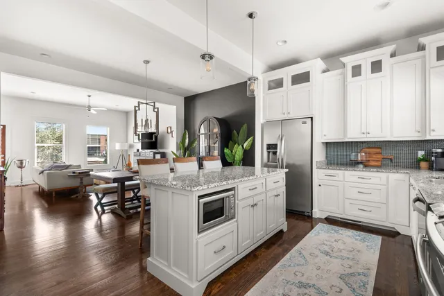 a kitchen with white cabinets and stainless steel appliances
