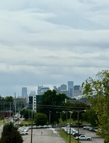 a spacious bedroom with a bed window and a table