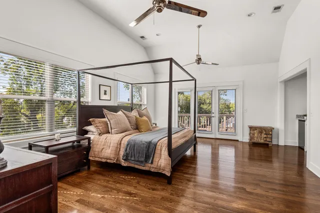 a bedroom with a large bed and a chandelier