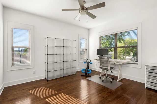 a view of a workspace with furniture and a window