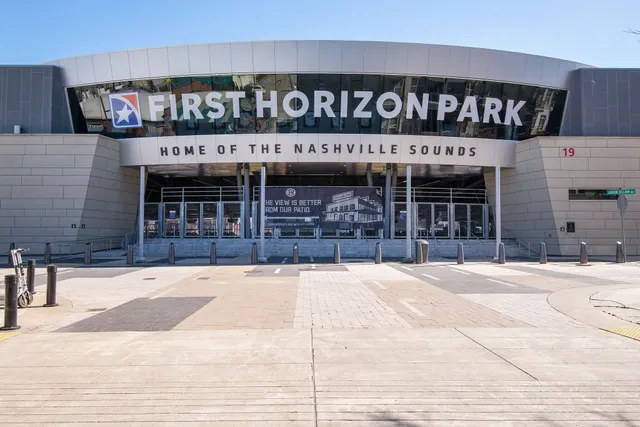 a street sign on a sidewalk next to a road