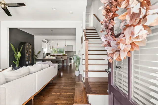 a living room with furniture and wooden floor