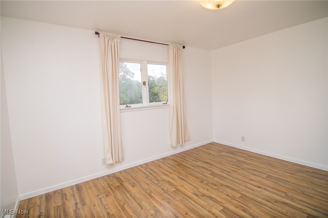 70973 Morristown Flushing Road Flushing, OH 43977 - Photo 34 of 44 Empty room with wood finished floors and baseboards