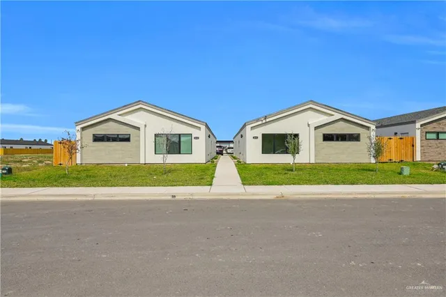 a view of front of house with a yard and garage