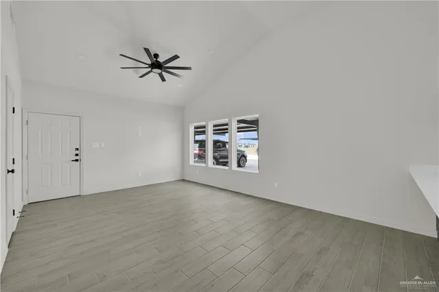 a view of a livingroom with a ceiling fan and window