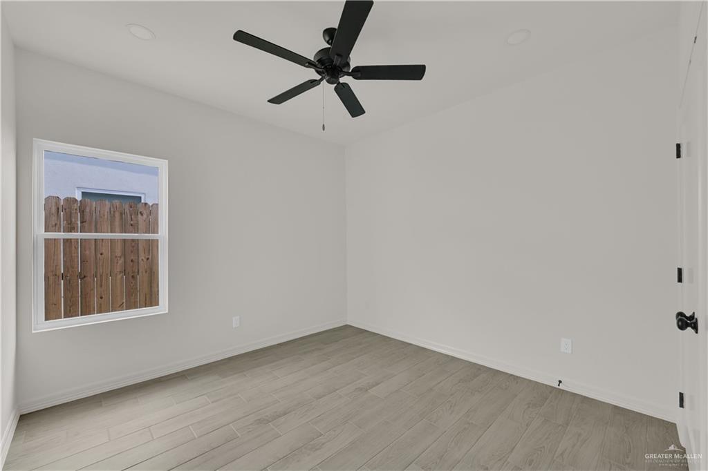 2612 Robin Road, Unit #3 Weslaco, TX 78596 - Photo 14 of 23 an empty room with a window and a ceiling fan